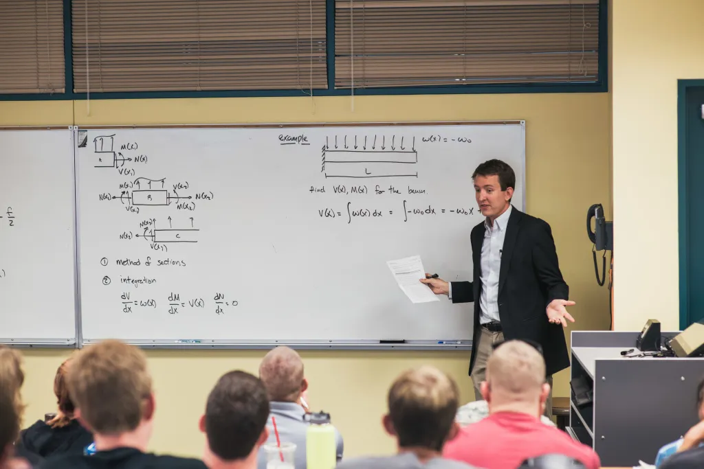 Faculty member teaching a math course at the whiteboard